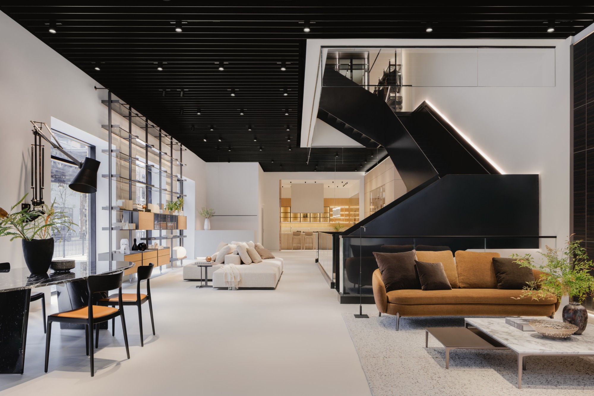 The ground floor, with seating, open shelving and the blackened-steel staircase
