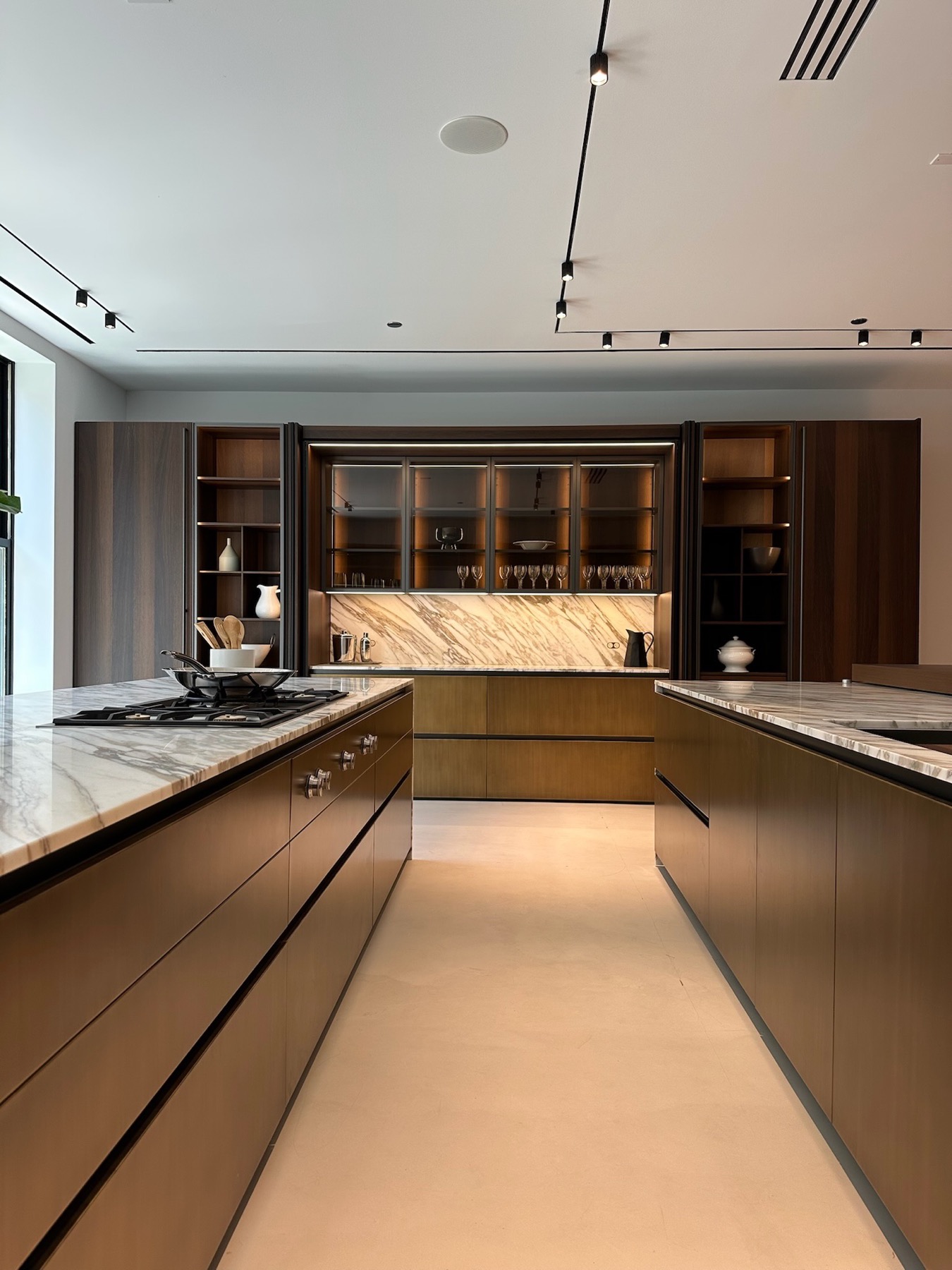 Between the working kitchen islands, toward a marble backsplash
